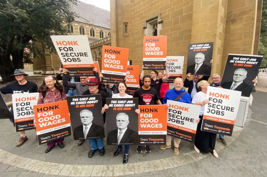 union members holding up corflutes saying honk for secure jobs