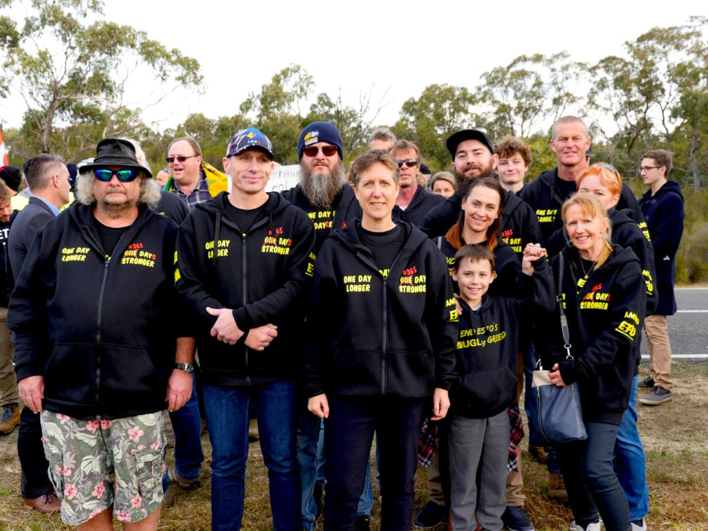 Sally McManus stands with AWU members at the one year anniversary rally