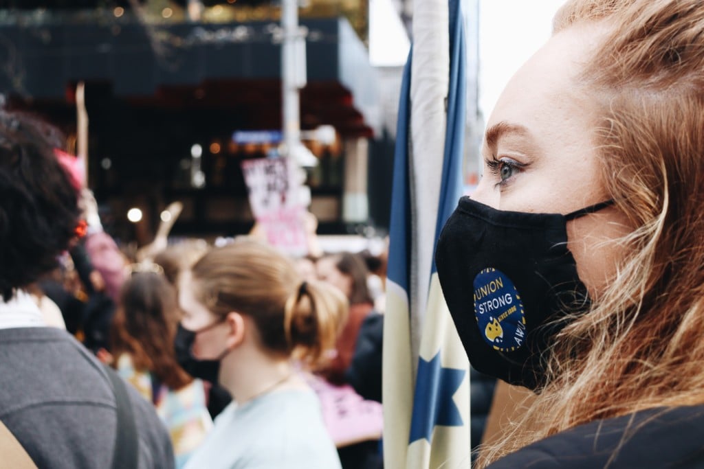 An Australian Workers Union member gazes out over a crowd of protesters